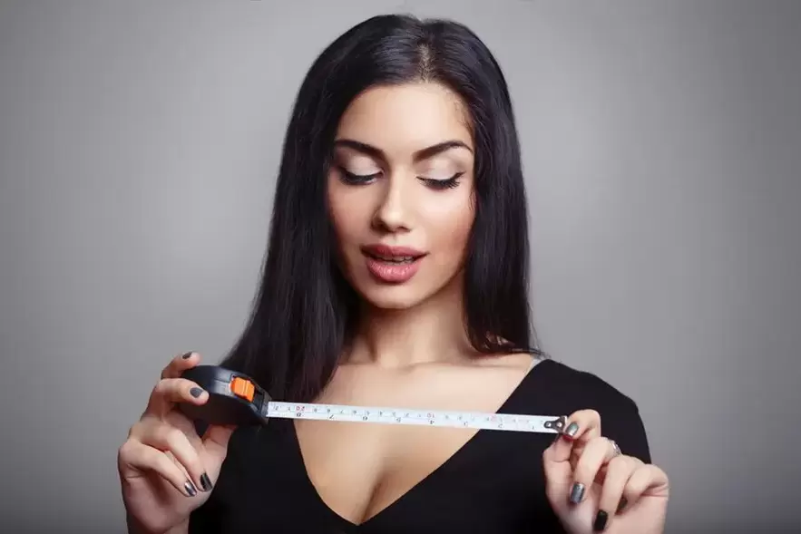 girl with a centimeter and measuring the penis after increasing the pump